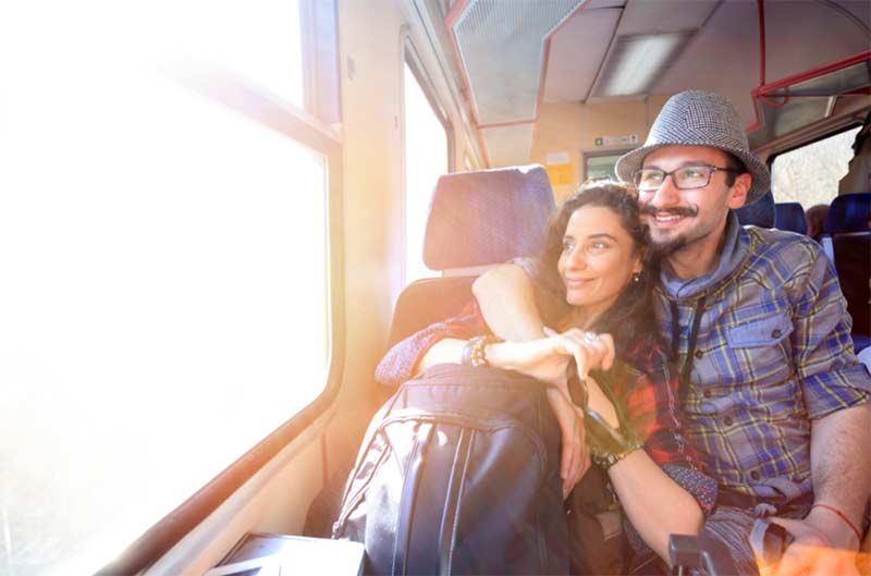 A man and woman hugging in a train