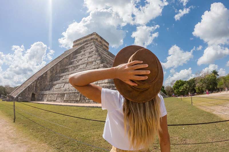 A girl in front of a pyramid